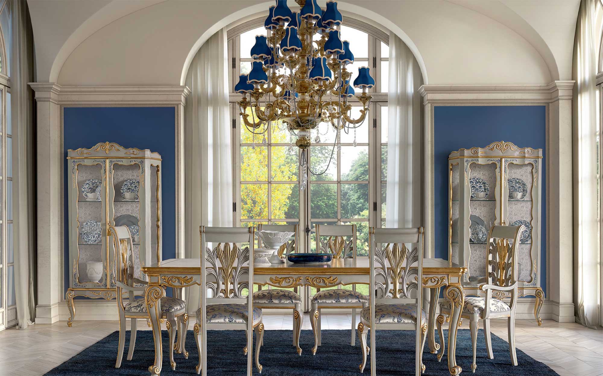 Classic dining room with gold carved wooden table and glass cabinets