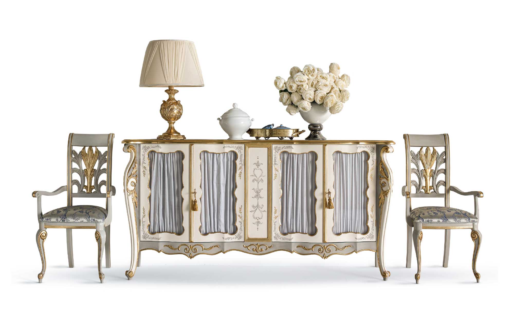 Classic sideboard with golden details and two carved armchairs in baroque style