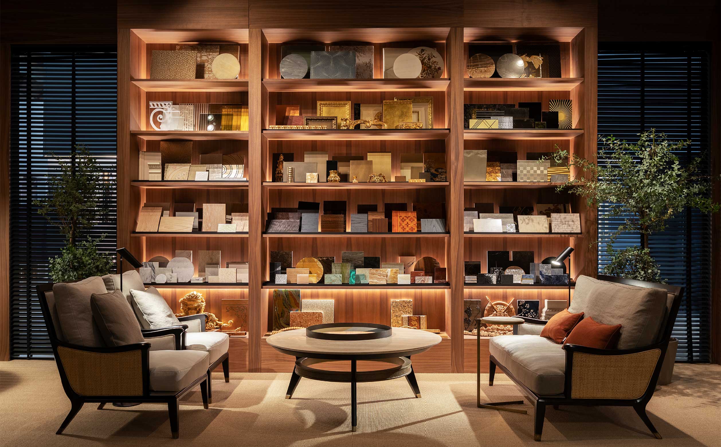 Lounge area with Medea furniture – Decorative library wall and refined seating composition